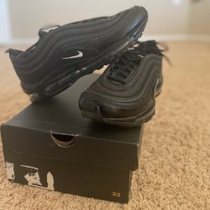 Nike Air Max 97 shoes in black, good condition with no noticeable flaws.